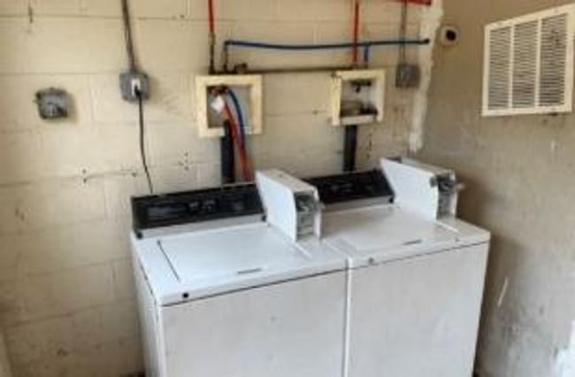 Washroom with separate washer and dryer and concrete block wall | Image 33