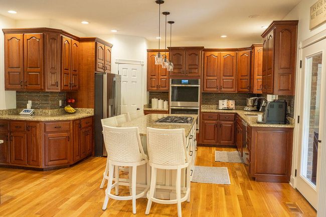 Kitchen with lots of beautiful cherry cabinets. Beautiful hard wood floors. | Image 19