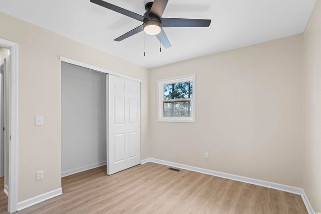 Unfurnished bedroom with light wood-type flooring, a closet, and ceiling fan | Image 30