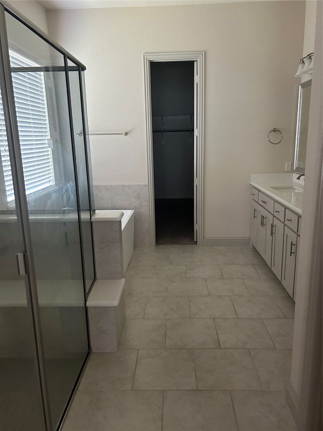 Full bath with vanity, a stall shower, a bath, and a spacious closet | Image 10