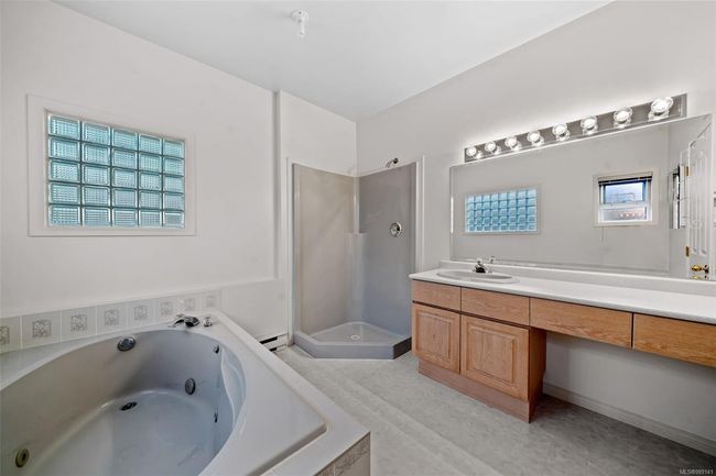 Primary Bathroom - Lower Level - A quote for new glass doors is available, and the seller is happy to have them installed upon an accepted offer, should the buyer choose | Image 24