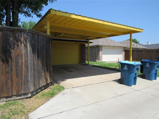 View of parking / parking lot featuring fence and a garage | Image 30