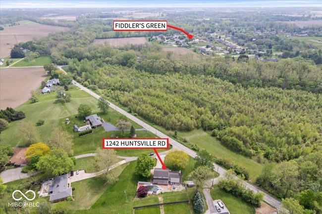 aerial overview of property's location with a heavily wooded area | Image 36