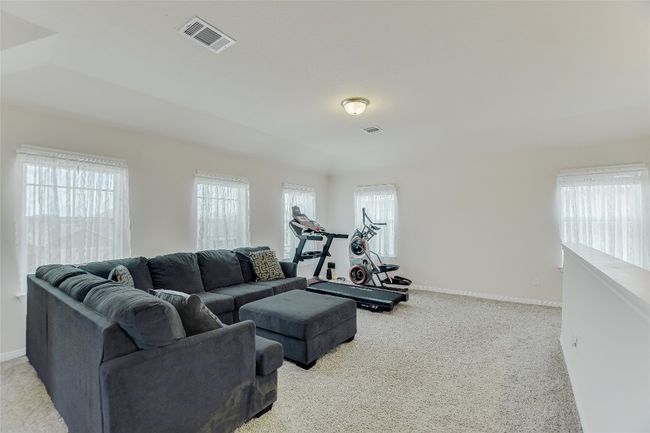 Exercise room featuring light colored carpet, healthy amount of natural light, and baseboards | Image 17