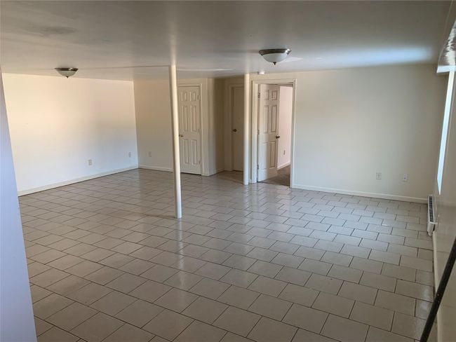 Spare room with baseboards and tile patterned floors | Image 6