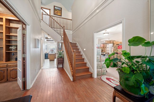 Hardwood floors welcome you into this grand foyer. This versatile floorplan offers 3 living areas and 2 dining spaces, as well as an office. | Image 17