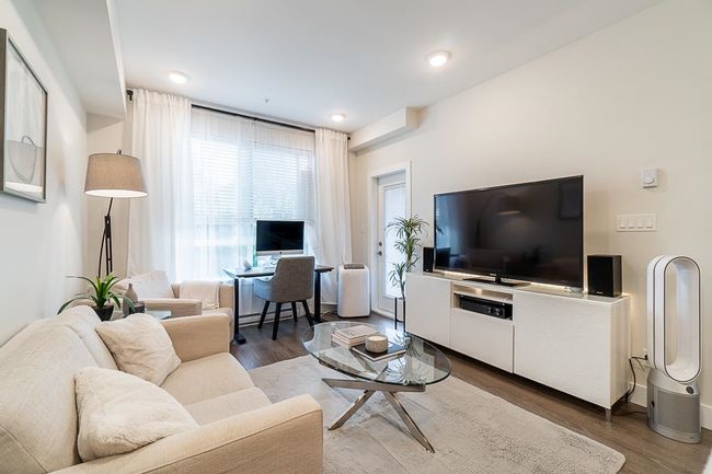 Living room featuring baseboards and wood finished floors | Image 8