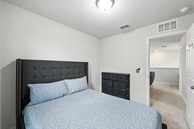 Bedroom with light carpet and baseboards | Image 35