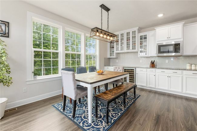 A Wine Refrigerator And Glass Doors Accent The Dining Room | Image 14