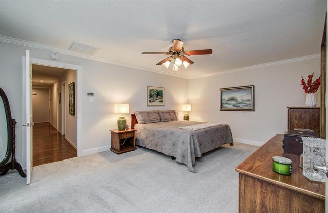 Primary bedroom features crown molding and plenty of room for king size furniture. | Image 20