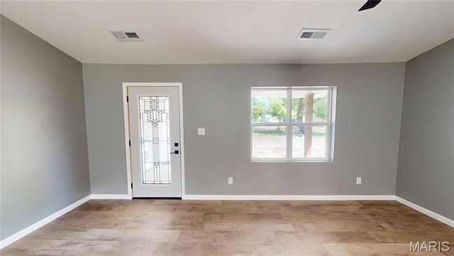 Foyer entrance featuring wood finished floors and baseboards | Image 4
