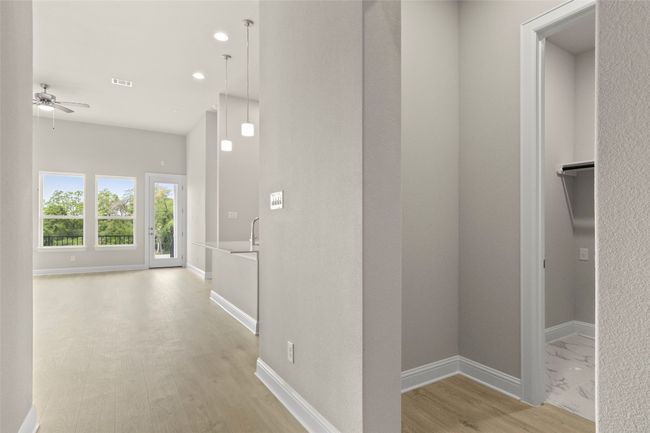 Hall with light wood-style floors, baseboards, and recessed lighting | Image 5