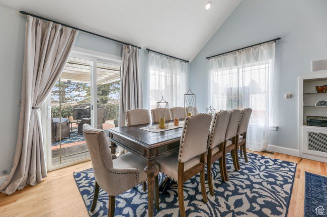 Dining space featuring high vaulted ceiling, baseboards, a wealth of natural light, and wood finished floors | Image 15