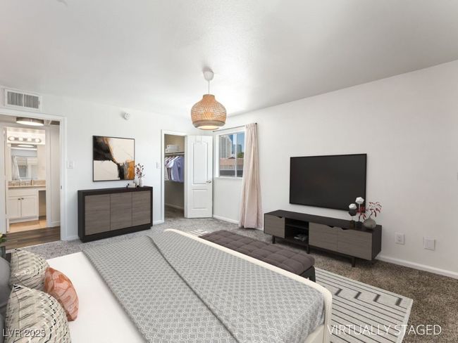 Carpeted bedroom with a walk in closet, a closet, and baseboards | Image 6
