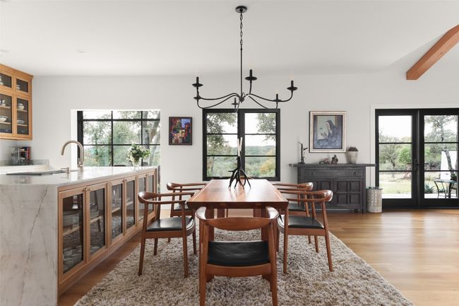 Dining area featuring an inviting chandelier, and plenty of natural light | Image 5
