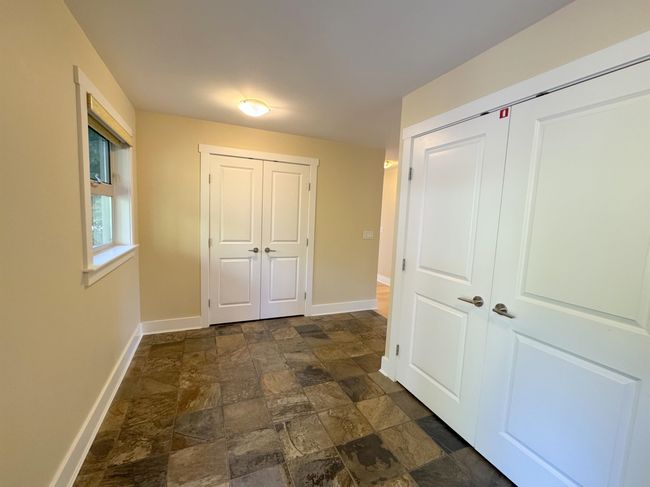 Hall featuring baseboards and dark stone finish floors | Image 32