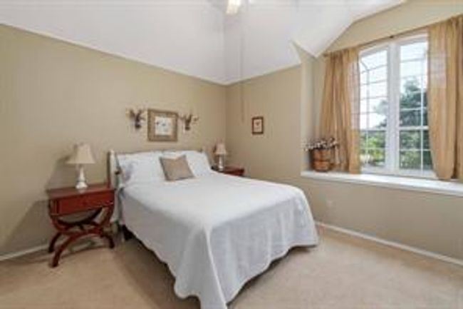 Bedroom featuring baseboards, carpet, lofted ceiling, and a ceiling fan | Image 28