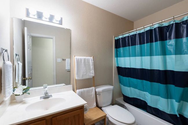 Full bathroom featuring vanity and shower / bath combo with shower curtain | Image 24