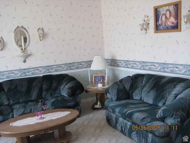 Living area with wallpapered walls and carpet floors | Image 13