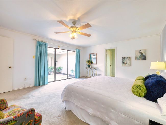 Carpeted bedroom featuring access to exterior, ceiling fan, and crown molding | Image 19