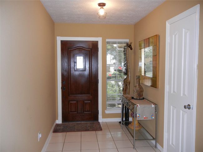 Step inside into this welcoming foyer with a window and coat closet. | Image 15