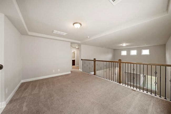 As you walk up the stairs to the 2nd floor, you are greeted with a game room that overlooks the living room. | Image 24