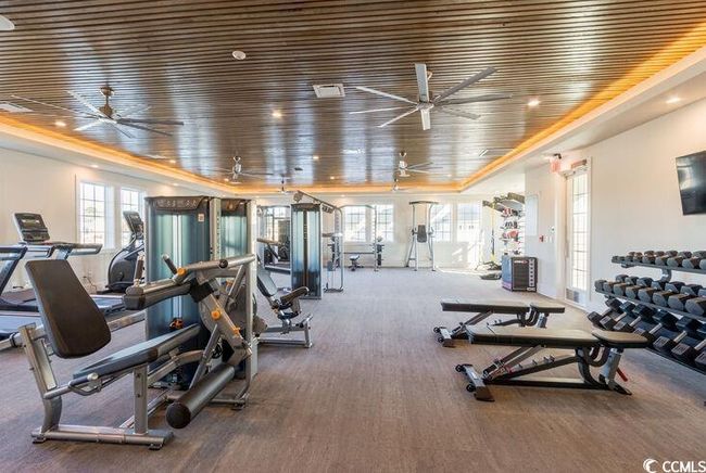 Exercise room with ceiling fan | Image 21