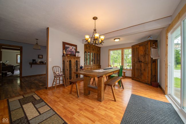 dining room featuring light wood-type flooring and a chandelier | Image 14
