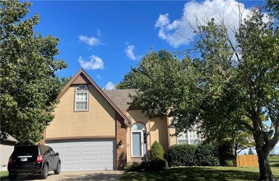 View of front property with a garage and a front yard | Image 1