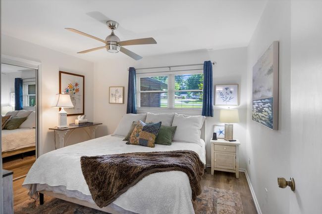 Bedroom featuring baseboards, wood finished floors, and ceiling fan | Image 21