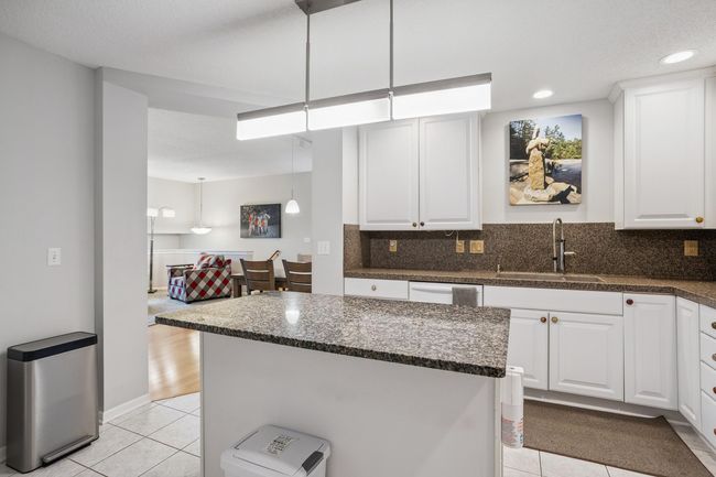Spacious and Work-Space Efficient Center Island Granite Kitchen | Image 11