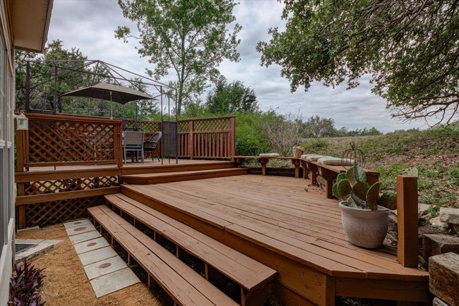 The terraced deck with outdoor dining area looks out over the golf course...great for entertaining or watching sunsets! | Image 21