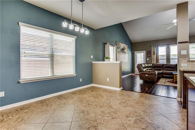 Tiled dining area with lofted ceiling and ceiling fan | Image 11