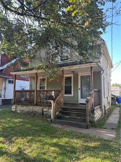 View of front of property with covered porch and a front yard | Image 2