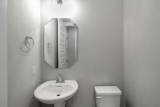 Bathroom featuring toilet and a textured wall | Image 22