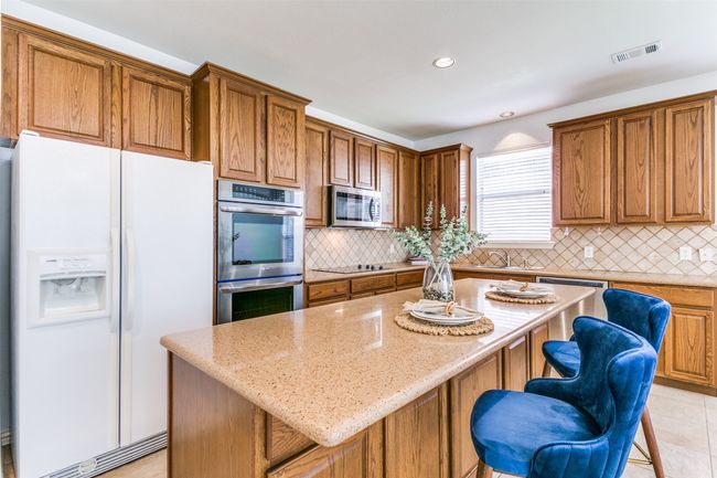 Beautiful granite countertops with a large Island for meal prep, or dining. | Image 5