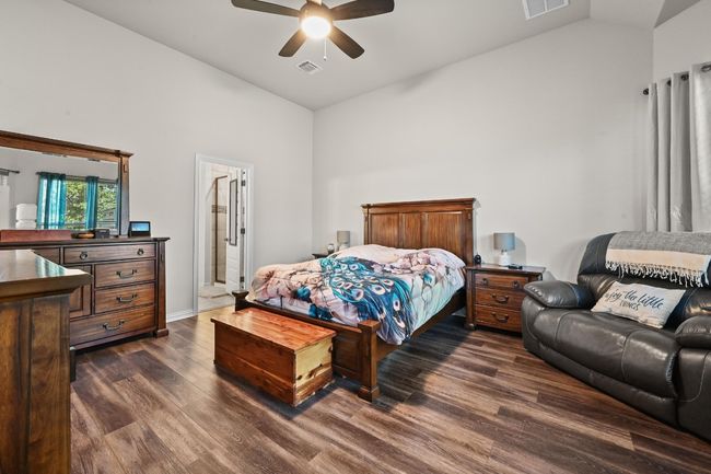 Bedroom featuring dark wood-type flooring, high vaulted ceiling, and ceiling fan | Image 13