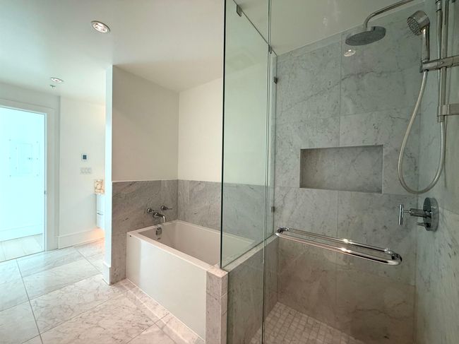 Full bath featuring marble finish floor, a stall shower, and a bath | Image 13