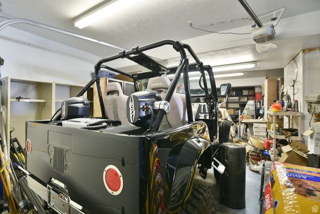 Garage featuring a garage door opener | Image 80
