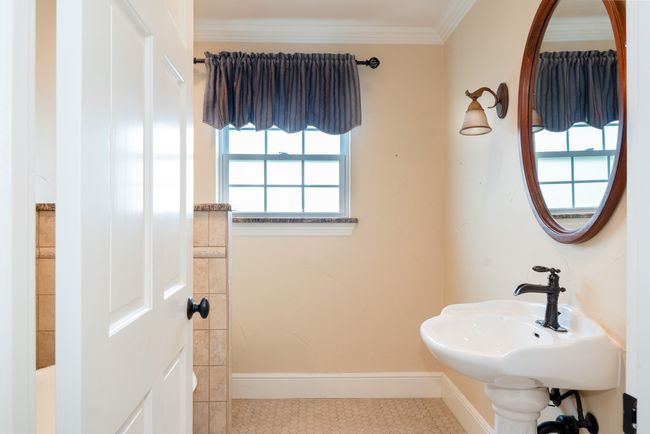 Bathroom featuring tile patterned floors and crown molding | Image 35