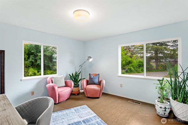 Main level bedroom with lots of windows and views of the gardens. | Image 16