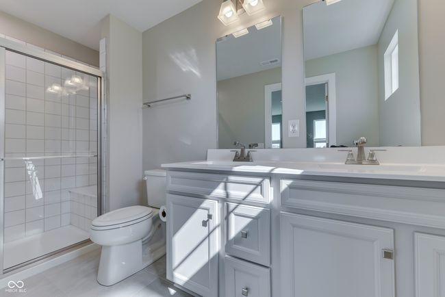 Spacious Master Bathroom with Quartz Counters and Double Sinks | Image 26