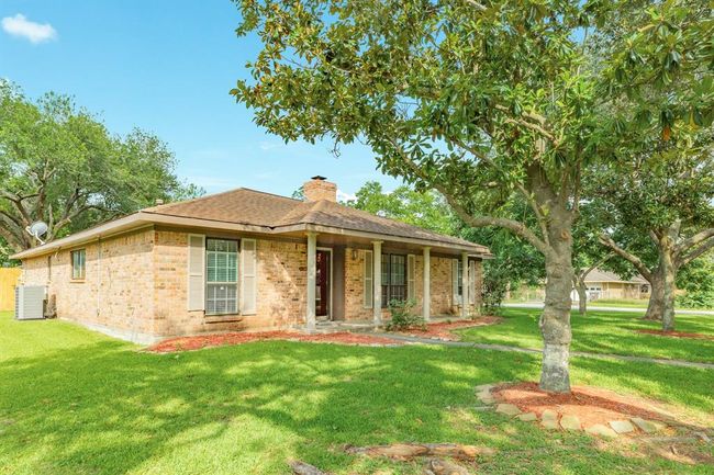 One story custom built brick ranch on a large corner lot, centrally located in the desirable Pearland community. The canopies from the tall trees provide shade from our Texas sun. Sit an relax with your favorite beverage on the expansive porch. | Image 33