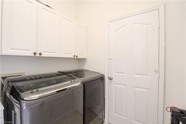 Laundry room with washer and dryer and cabinets | Image 15