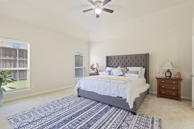 Bedroom featuring light carpet, baseboards, and a ceiling fan | Image 12