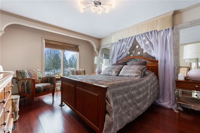 View of bedroom 2 with hard wood flooring. Beautiful lighting. | Image 30