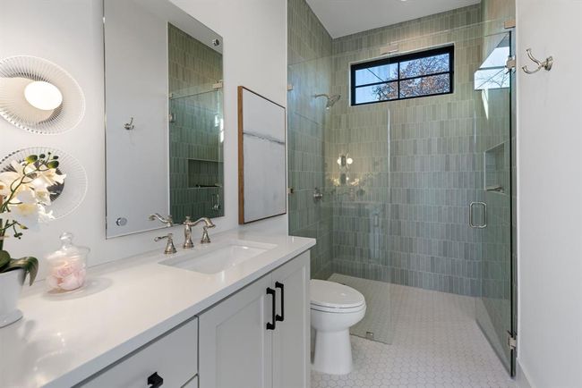 Full bath featuring vanity, a shower stall, toilet, and tile patterned floors | Image 39