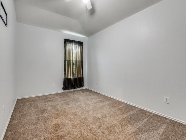 Carpeted spare room featuring a ceiling fan and baseboards | Image 20