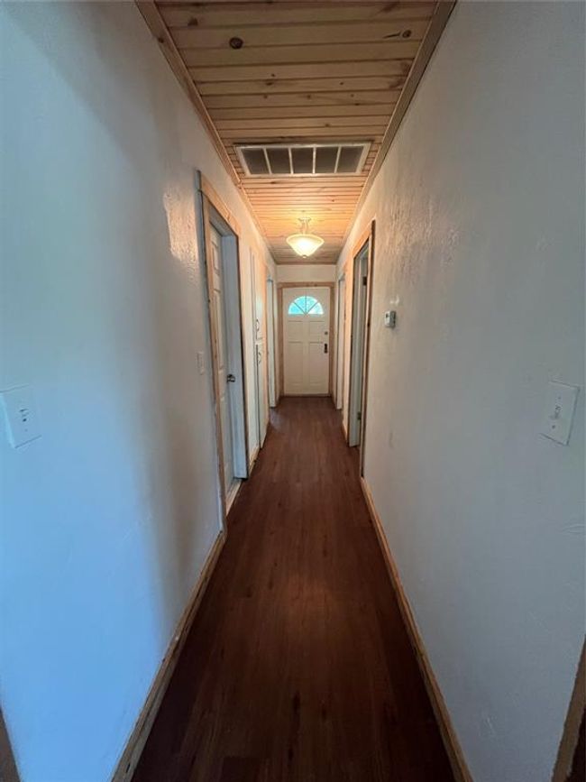Hallway featuring baseboards, dark wood-style floors, and wooden ceiling | Image 14