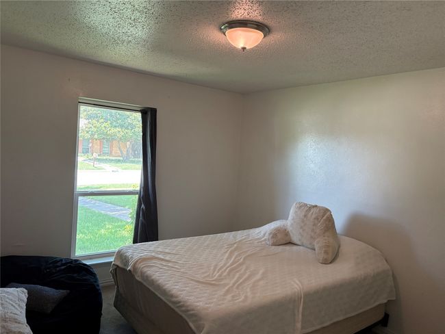 Bedroom featuring a textured ceiling | Image 10